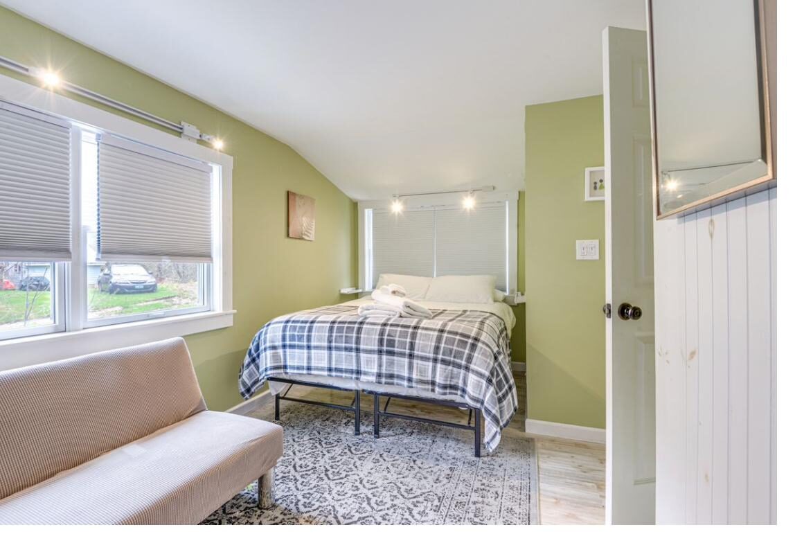 Green bedroom with bed and futon