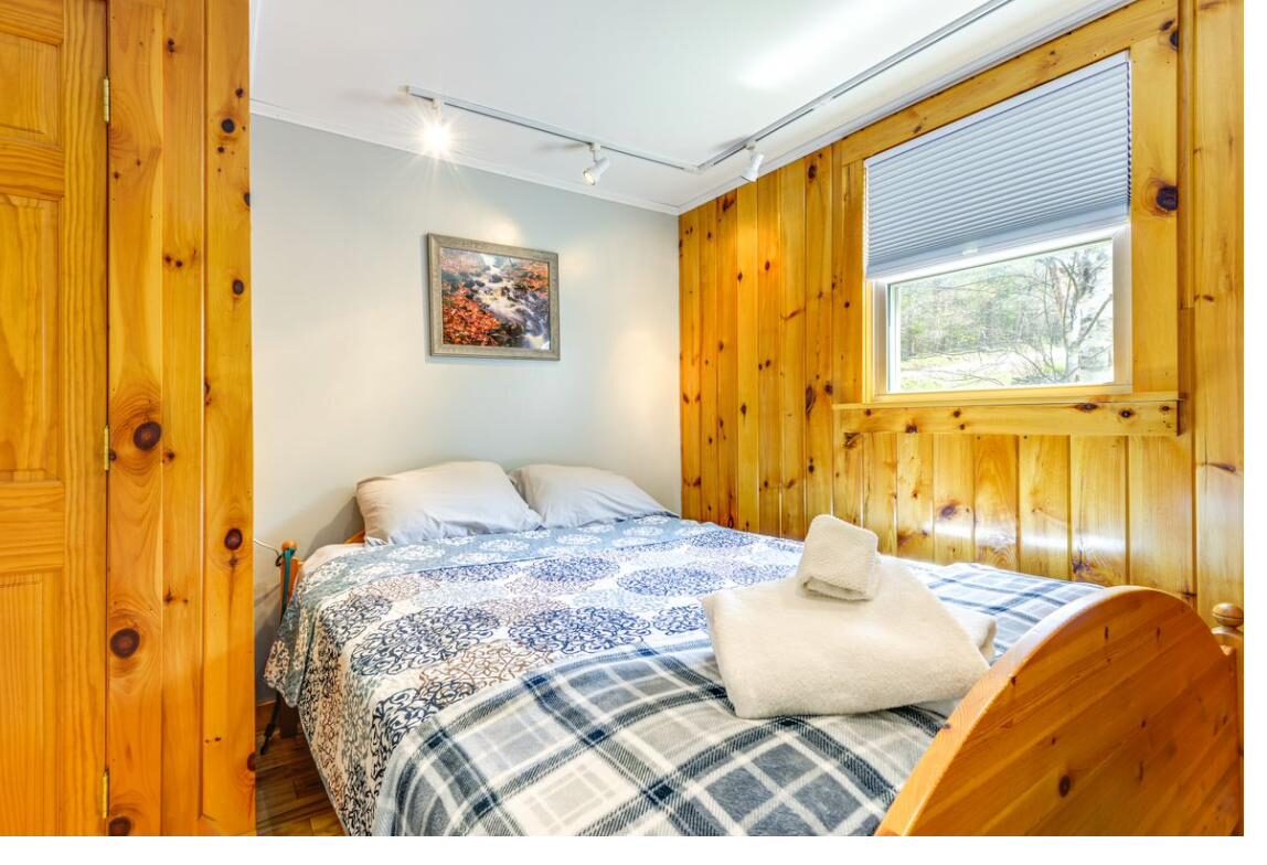 Knotty pine bedroom with plaid bedding