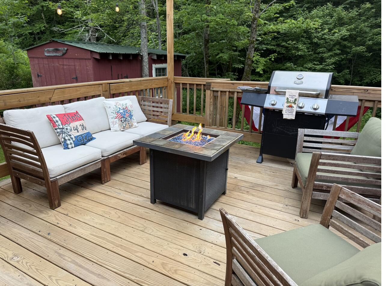 Back deck with outdoor sofas and fire table