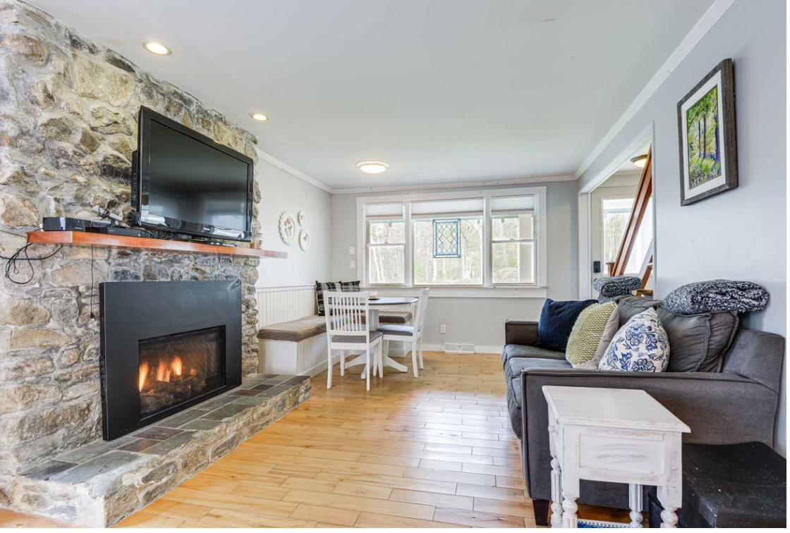 Living room stone fireplace with TV